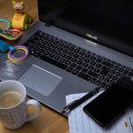 PC portatile con tazza da caffè e giochi bimbi, a simboleggiare equilibrio tra lavoro e vita familiare